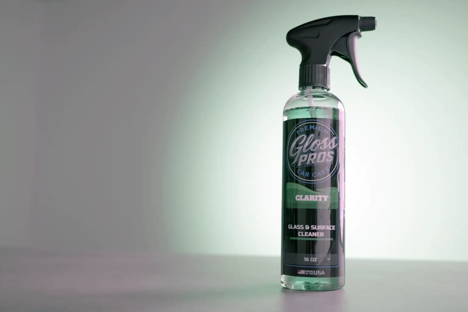 Streak-free car glass being cleaned with a microfiber towel in a premium garage setting