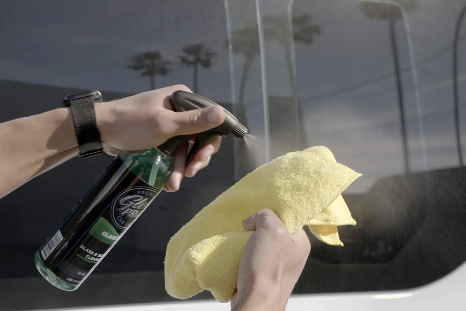 Two towel method diagram for cleaning glass: spray towel, wipe, then buff dry with a second towel