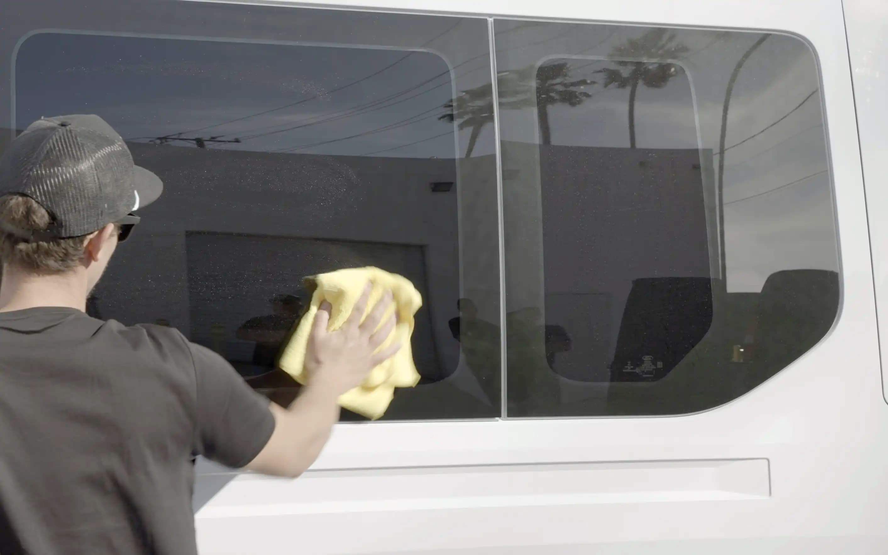 Interior vs exterior glass wipe pattern diagram showing vertical strokes inside and horizontal strokes outside