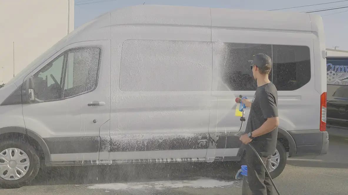 Thick foam clinging to a vehicle panel during a pre-wash stage